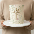 Decorative cake with a cross and dove design on a white background